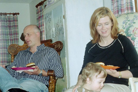 Man and Woman Enjoying Food with Child Man and Woman Enjoying Food with Child