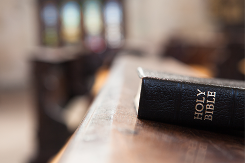 Holy Bible on a Wooden Church Bench